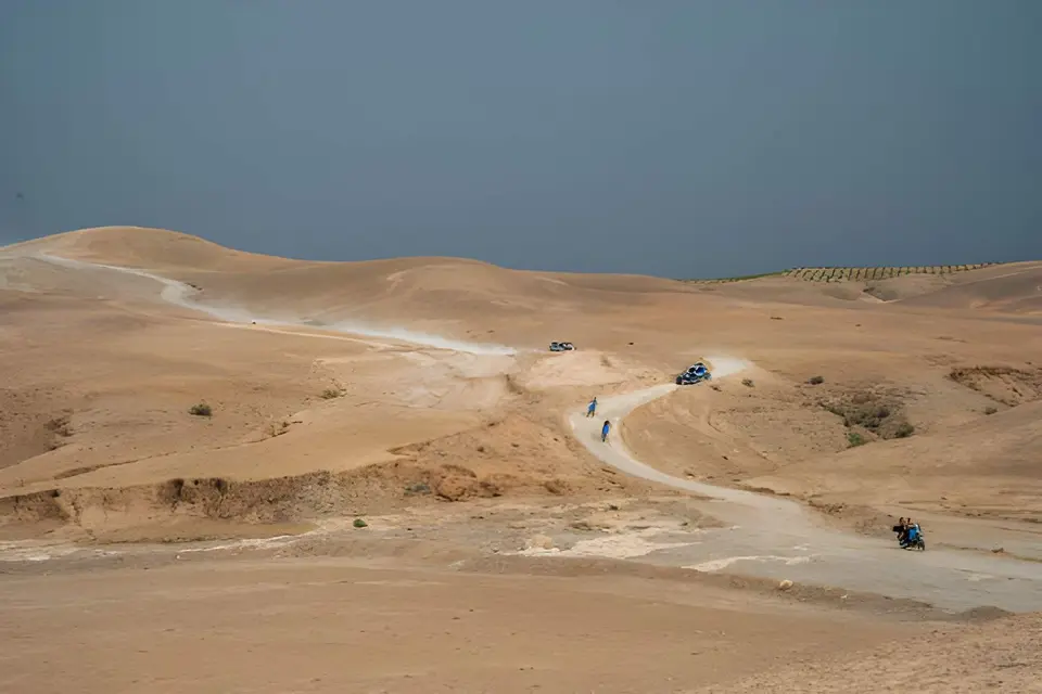 Quad bikes on a dirt track winding across the stone desert