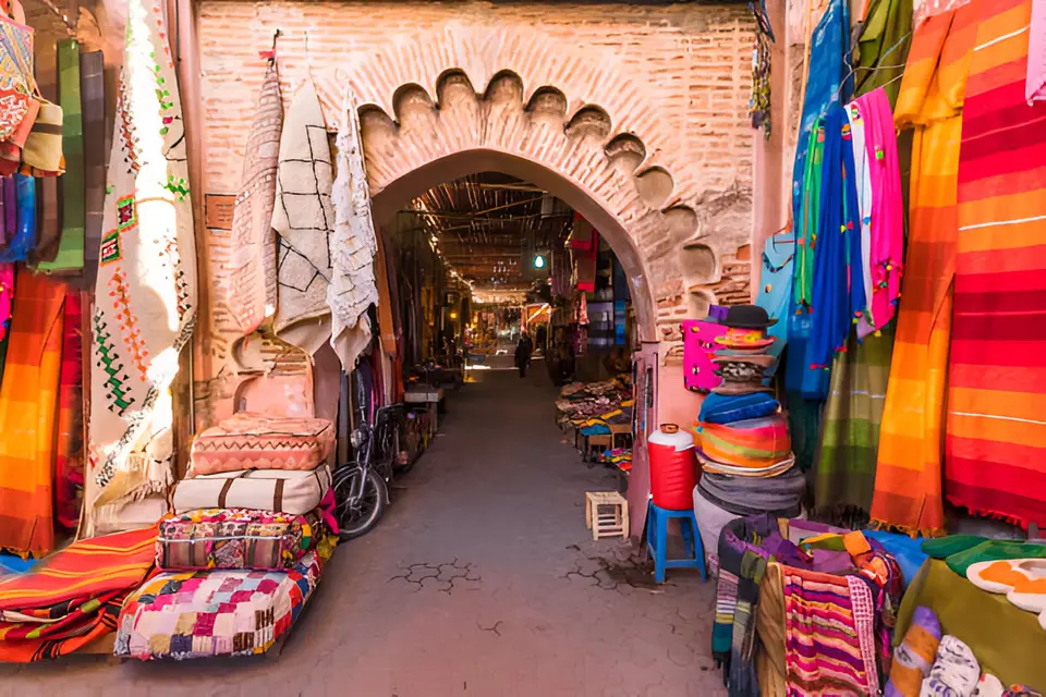 A souk archway hung with rugs, cushions and bright textiles